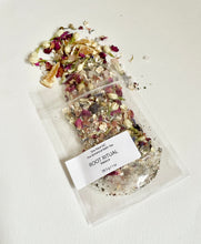 Load image into Gallery viewer, Sample pouch of Root Ritual bath tea with dried botanicals spilled on a white background.