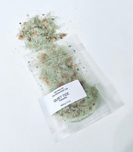 Load image into Gallery viewer, Sample pouch of Quiet Tide bath salt with green and pink mineral salts spilled on a clean white background.
