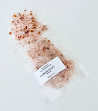 Load image into Gallery viewer, Sample pouch of Harbor Reset bath soak with pink mineral salts spilled on a clean white background.