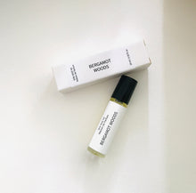 Load image into Gallery viewer, Bergamot Woods perfume oil roller bottle with matching minimalist white box on a light background