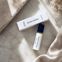 Load image into Gallery viewer, Sea Salt & Neroli perfume oil from the Maison de Parfum collection with matching box, styled on a light marble surface with a stone slab, white flowers, and draped satin fabric.