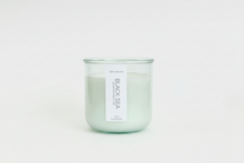 Load image into Gallery viewer, Black Sea natural wax candle in a green tinted recycled jar on a white background, hand-poured in Wilmington, North Carolina