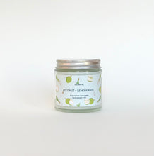 Load image into Gallery viewer, On a white studio background, a coconut and lemongrass candle is displayed, hand poured in Wilmington, North Carolina