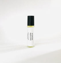 Load image into Gallery viewer, Southern Magnolia perfume oil roller bottle with minimalist white label and black cap.
