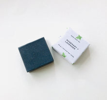 Load image into Gallery viewer, Black charcoal soap bar with rosemary and lavender scent packaging displayed on a soft white surface.
