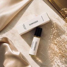 Load image into Gallery viewer, SUNKISSED perfume oil by Maison de Parfum with matching box, styled on warm marble with champagne satin, golden sunlight, and delicate dried flowers for a luxurious editorial look.
