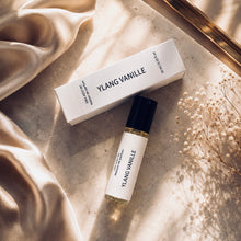 Load image into Gallery viewer, YLANG VANILLE perfume oil by Maison de Parfum with matching box, styled on warm marble with champagne satin, golden sunlight, and delicate dried flowers for a luxurious editorial look.
